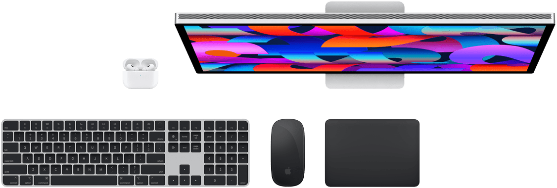 Top view of Mac accessories: Studio Display, AirPods, Magic Keyboard, Magic Mouse, and Magic Trackpad